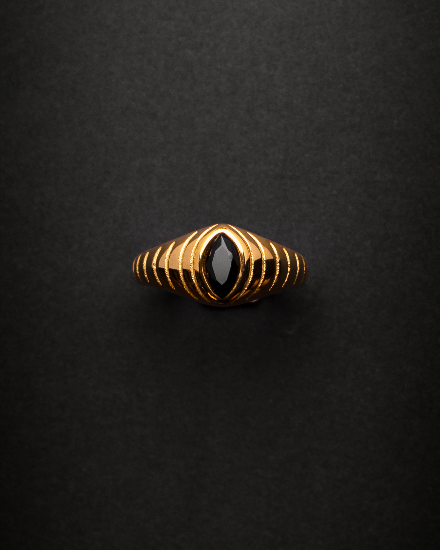 Gold ring with a black gemstone 