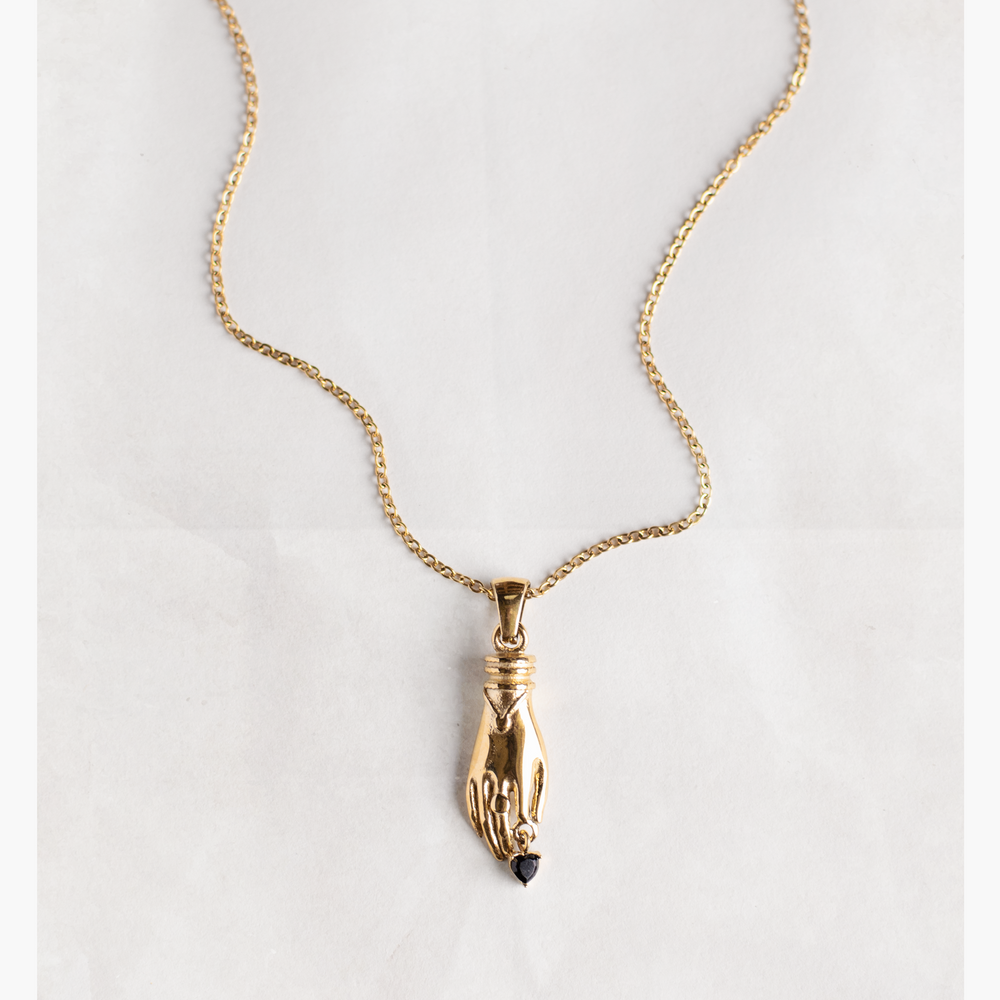
                  
                    Gold necklace with unique vintage inspired hand pendant with a black heart shaped gemstone, materials used a waterproof and tarnish resistant
                  
                