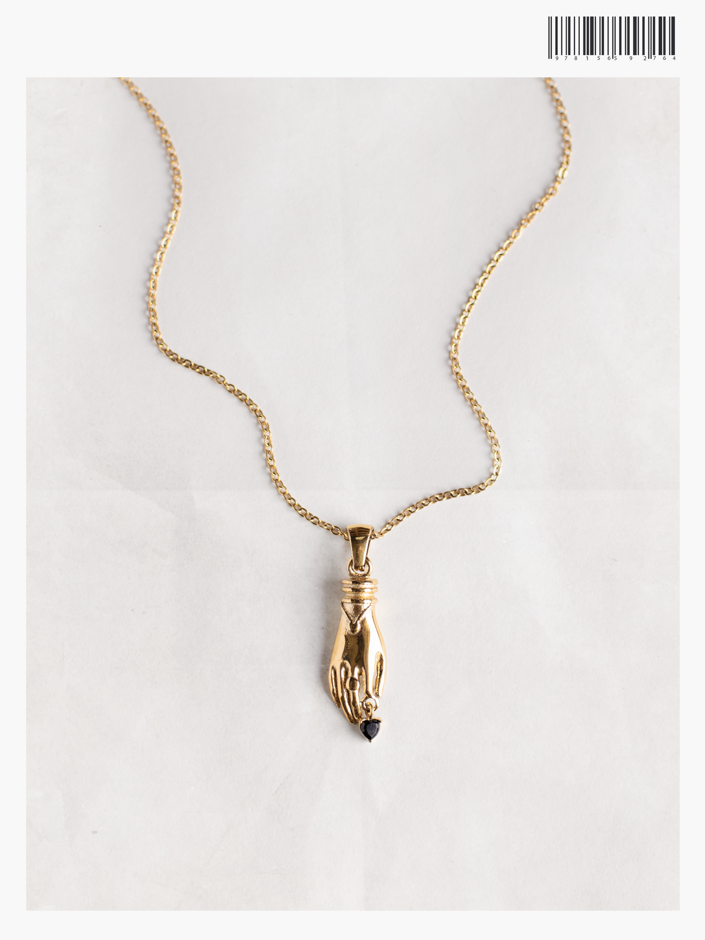 Gold necklace with unique vintage inspired hand pendant with a black heart shaped gemstone, materials used a waterproof and tarnish resistant