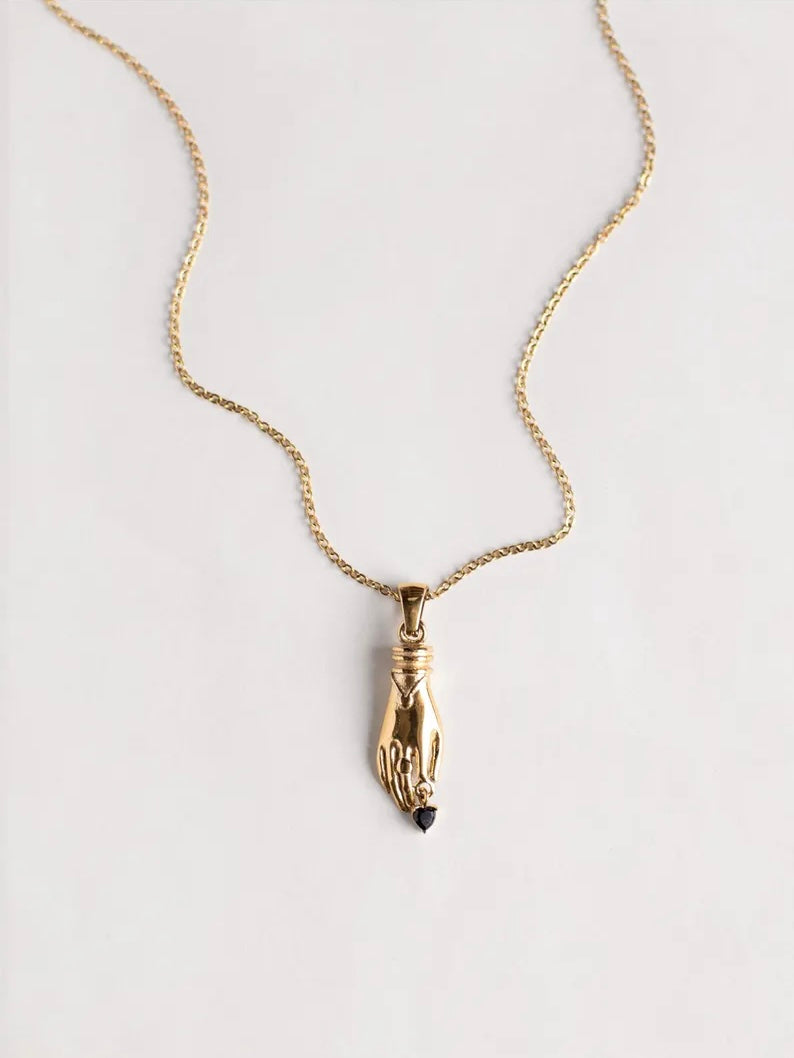 Gold necklace with unique vintage inspired hand pendant with a black heart shaped gemstone, materials used a waterproof and tarnish resistant