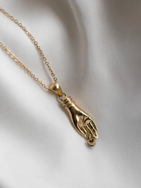 
                  
                    Gold necklace with unique vintage inspired hand pendant with a black heart shaped gemstone, materials used a waterproof and tarnish resistant
                  
                